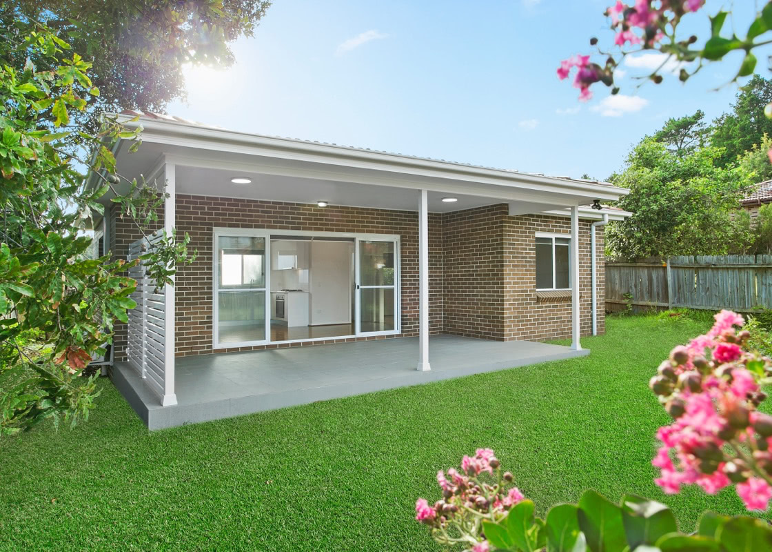 granny flat backyard with brick facade and lawn